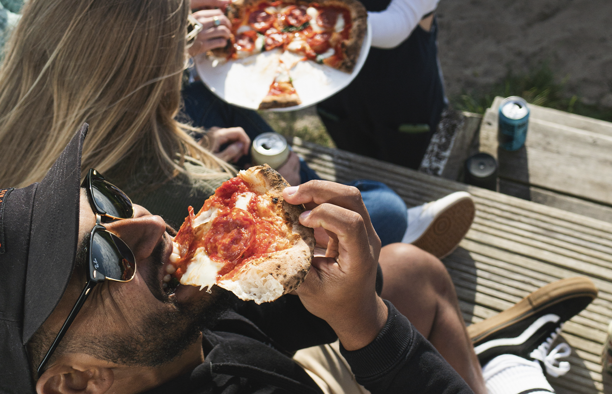 eating pizza outdoors
