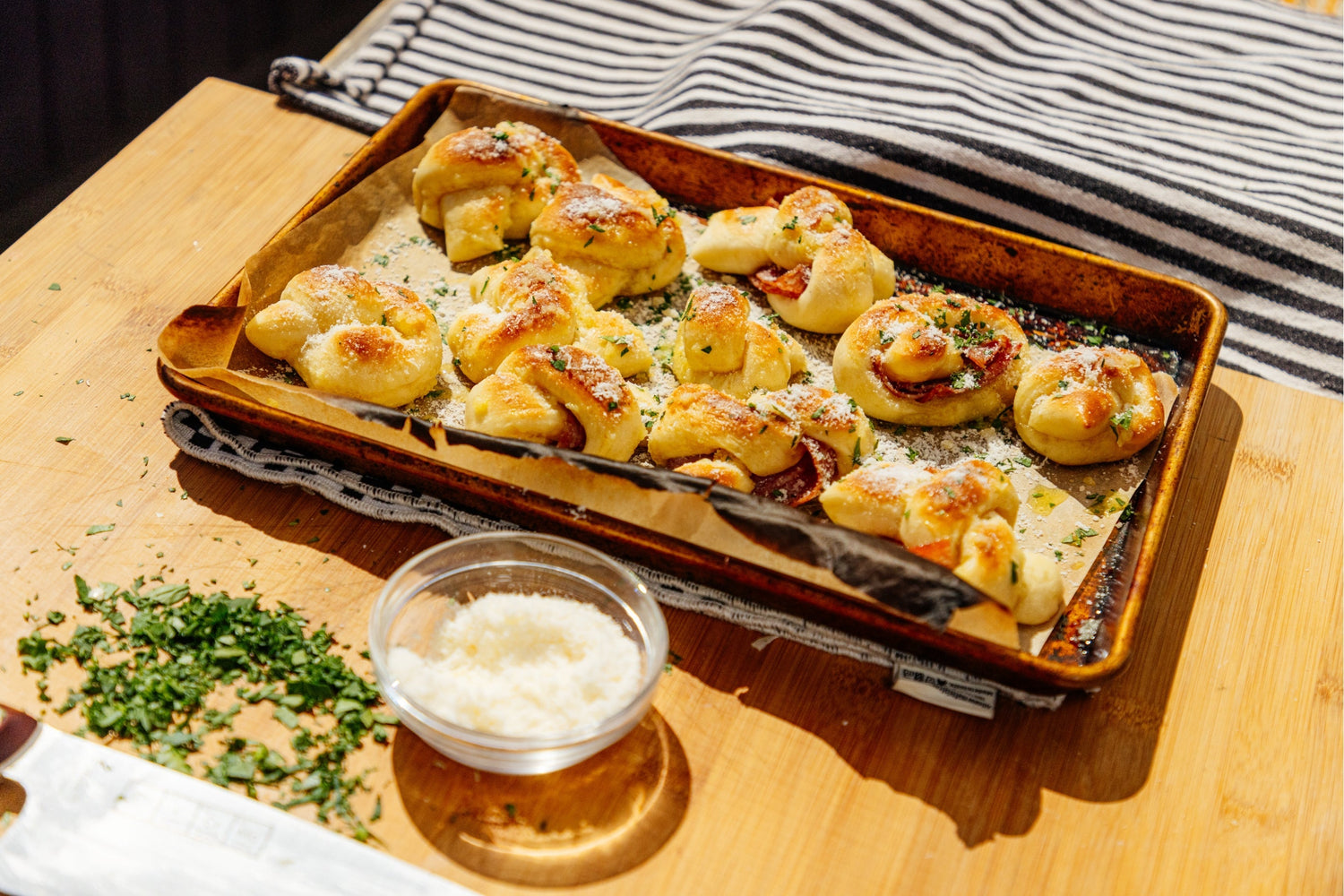 Presented Garlic Knots next to a side of cheese