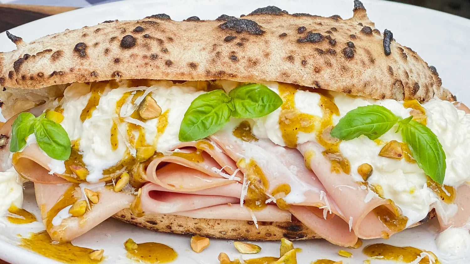 Mortadella Panuozzo with Stracciatella, Pistachio Pesto and Pecorino Romano