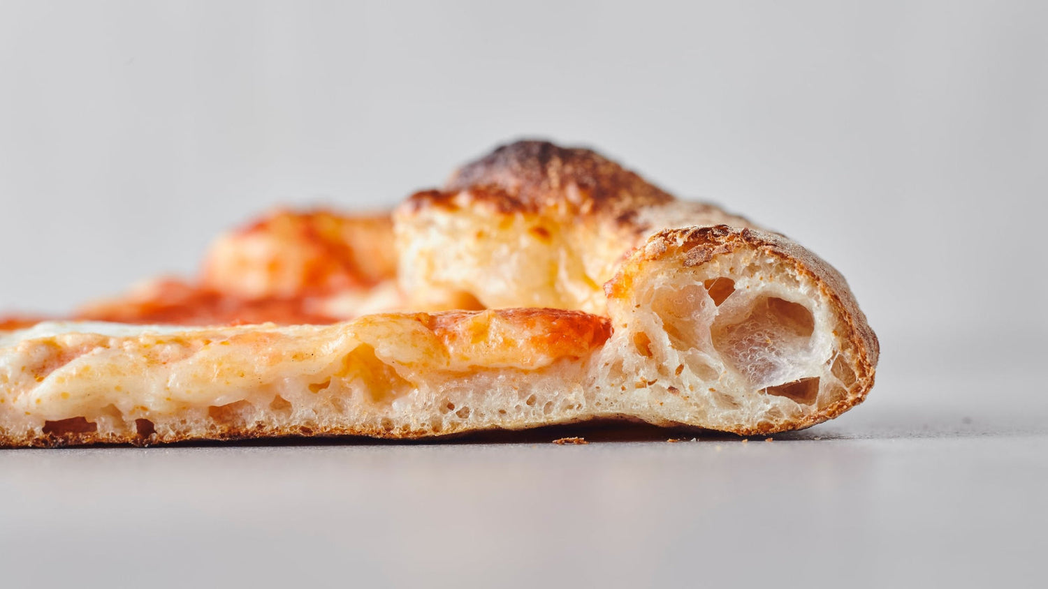 Side profile of a slice of pizza recipe poster image